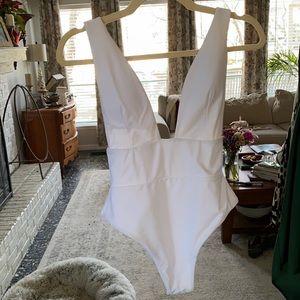 White one piece swimsuit with plunging neckline. Perfect for honeymoon!